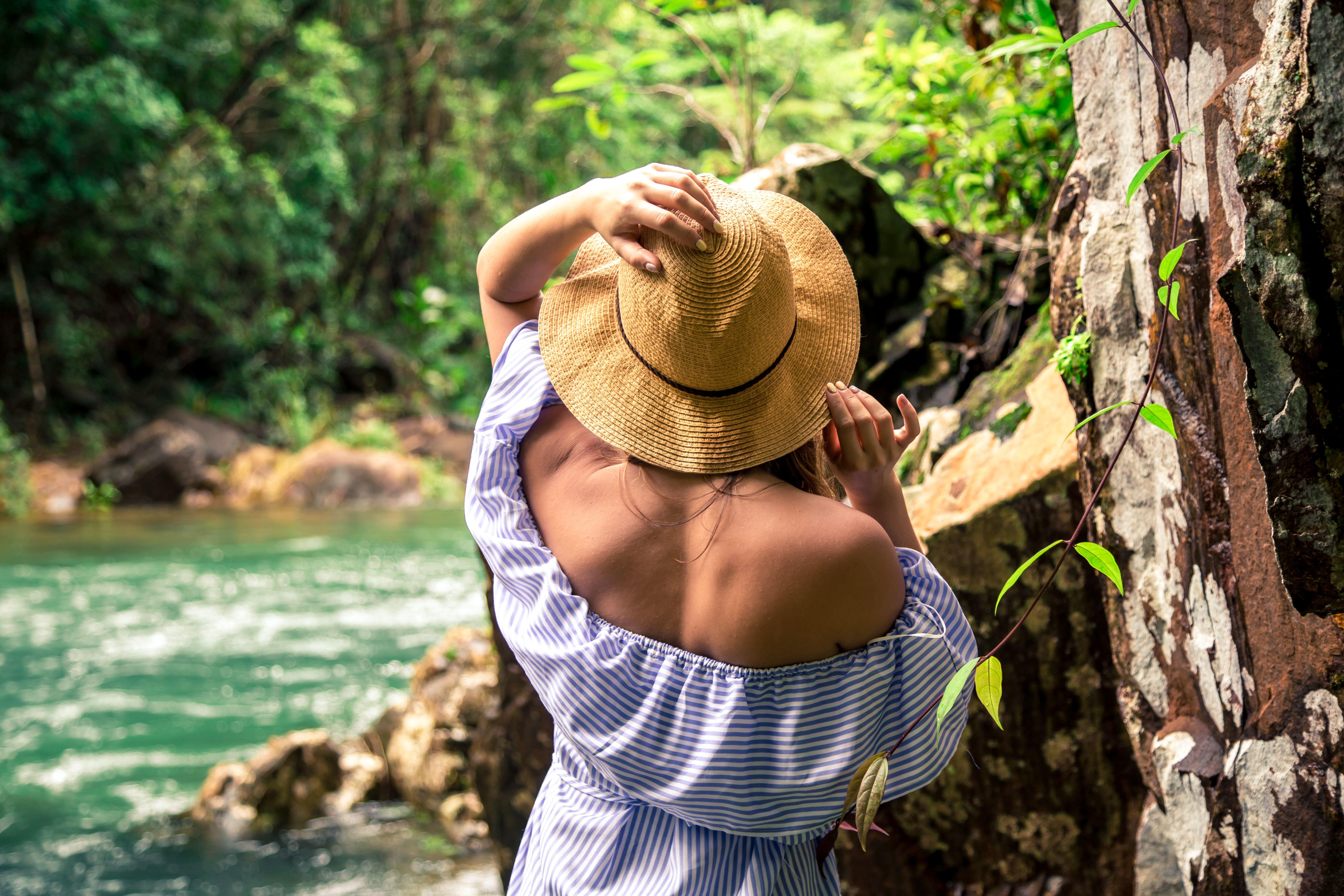 Photograph of women looking at river view in a forest.